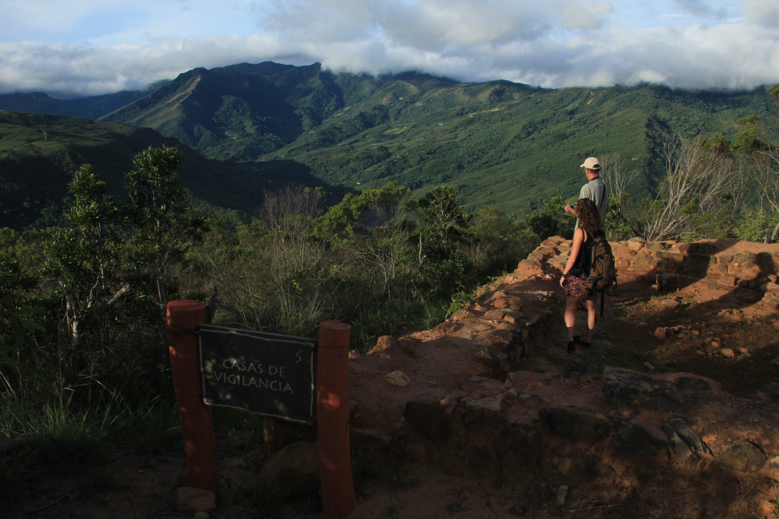 Tourists look at the Andes Mountains surrounding El Fuerte de Samaipata in Bolivia.