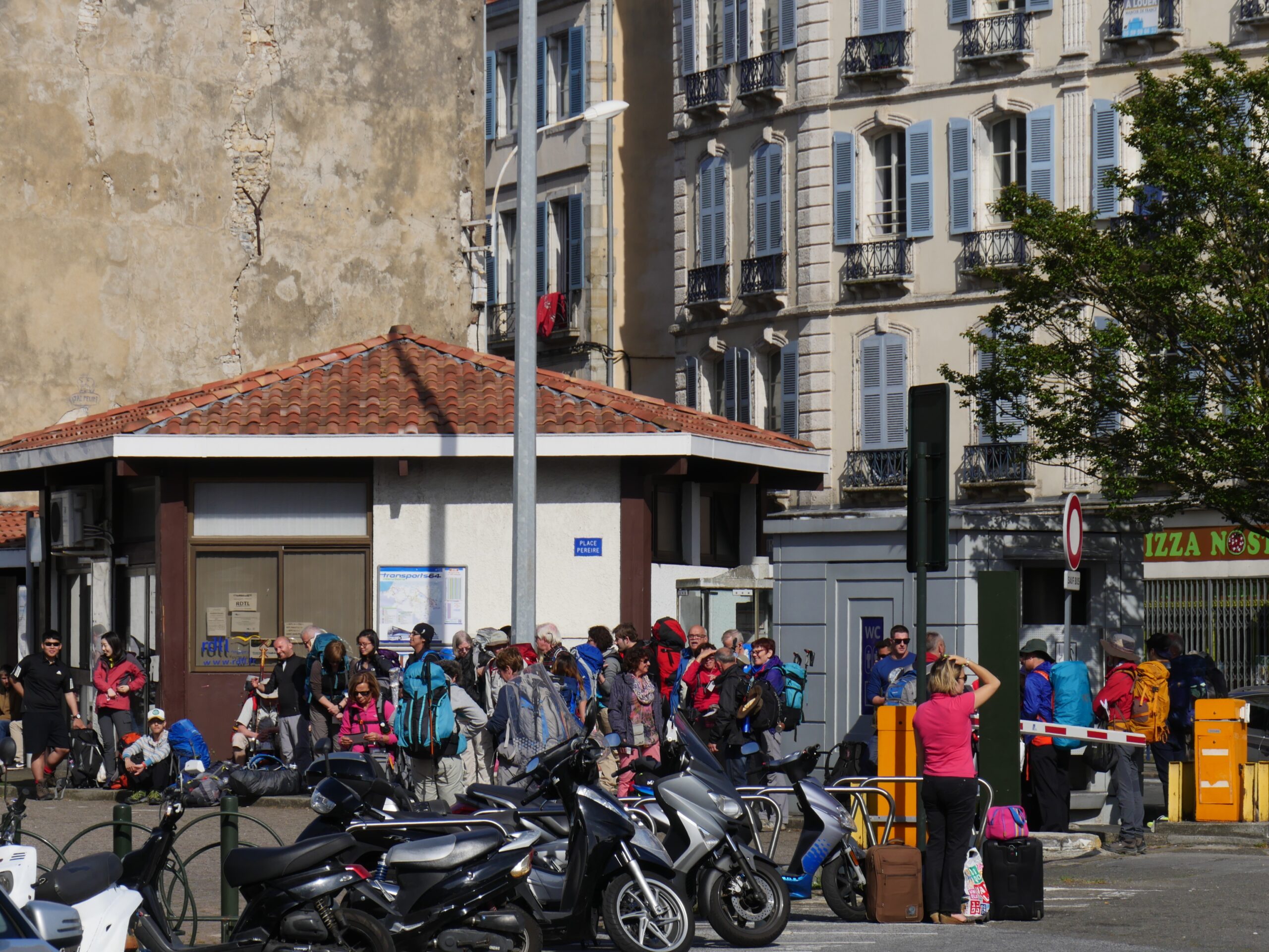 Pilgrims gather for a bus departure to Saint-Jean-Pied-de-Port, France to begin hiking the famous Camino de Santiago.