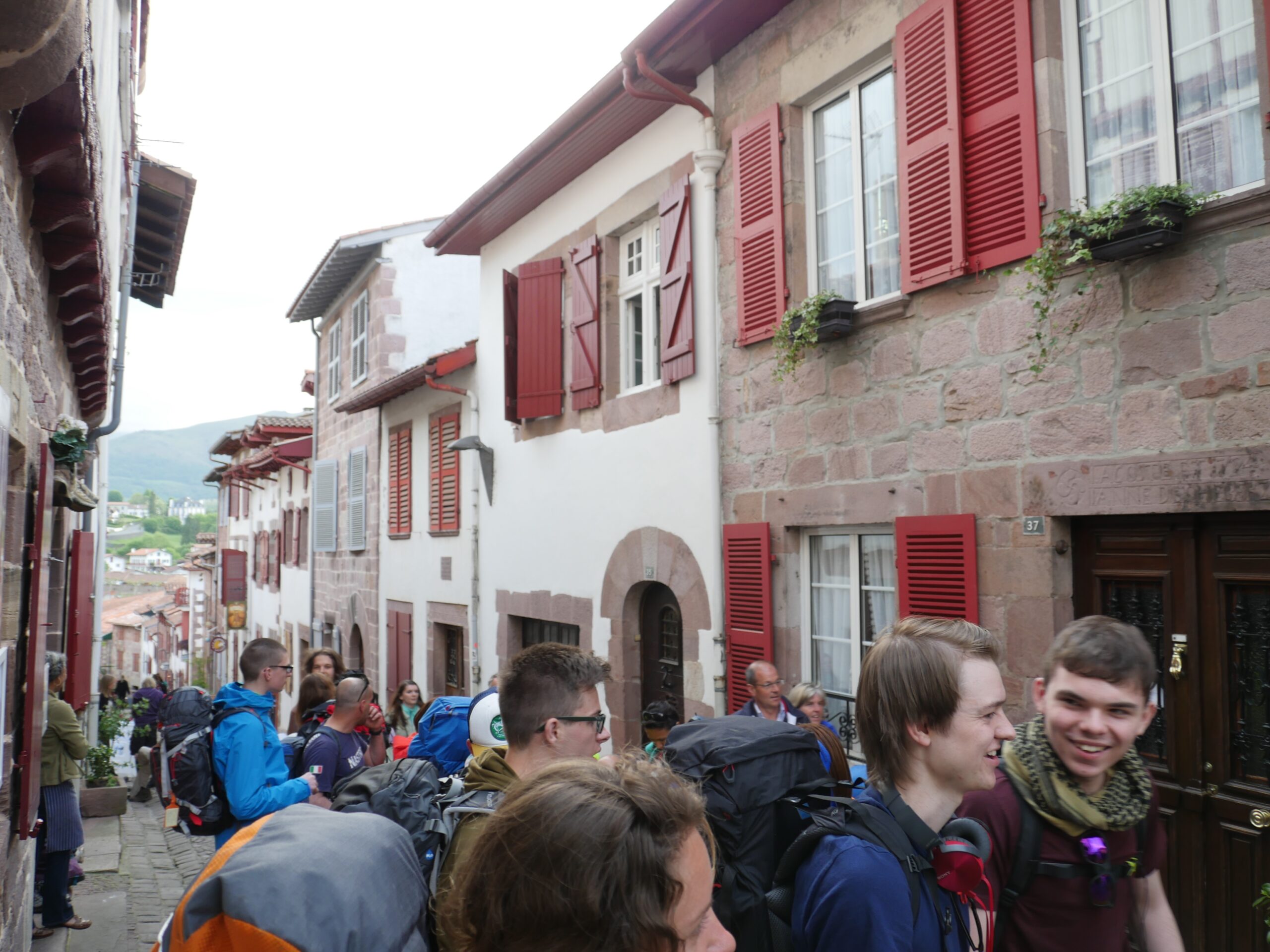 Pilgrims wait in line in Saint-Jean-Pied-de-Port, France to obtain their pilgrim&#039;s passport before beginning their trip on the Camino de Santiago.