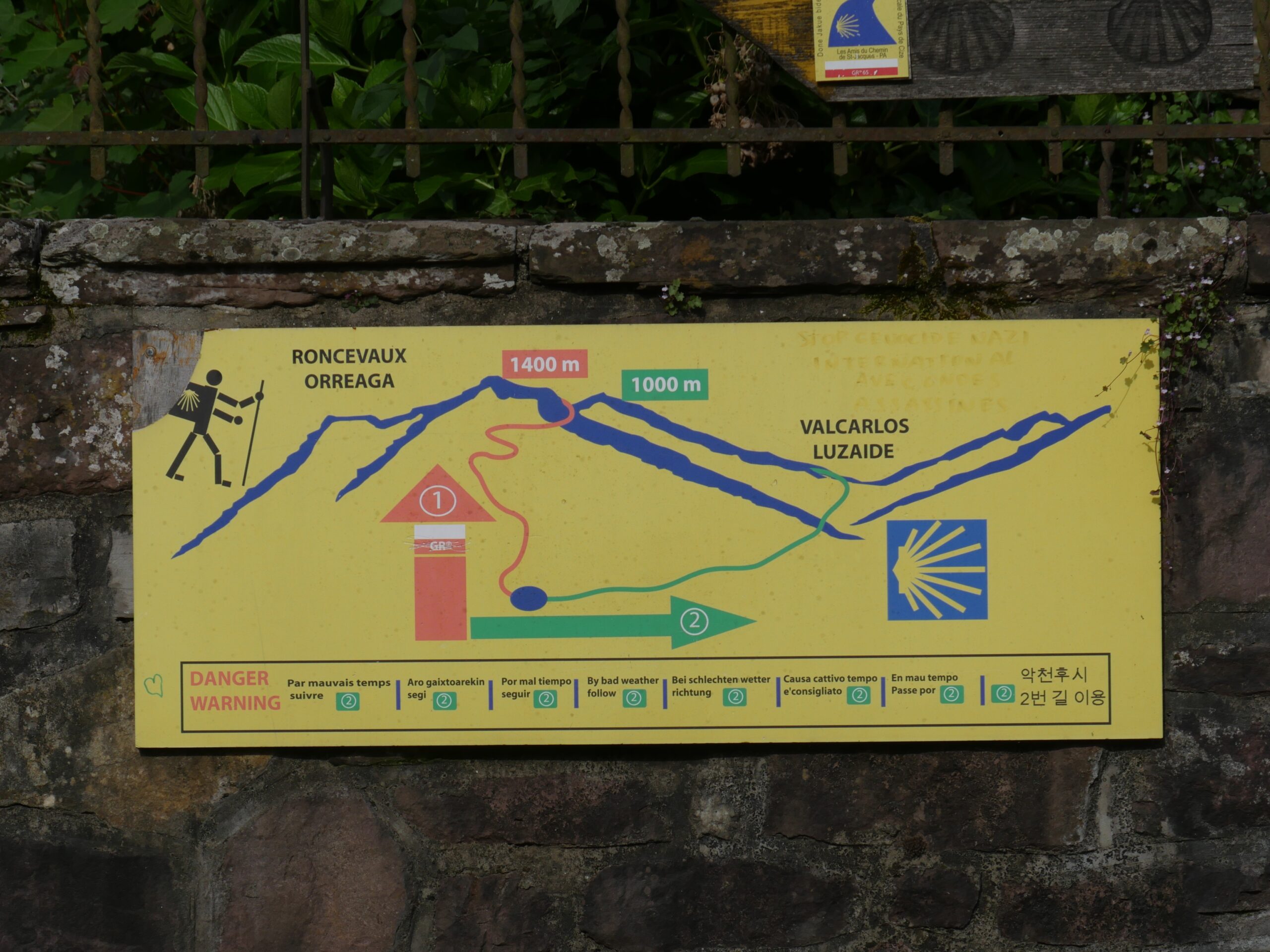 A sign warns Camino de Santiago pilgrims of the dangers of attempting the difficult Napoleon Route leading through the French Pyrenees.