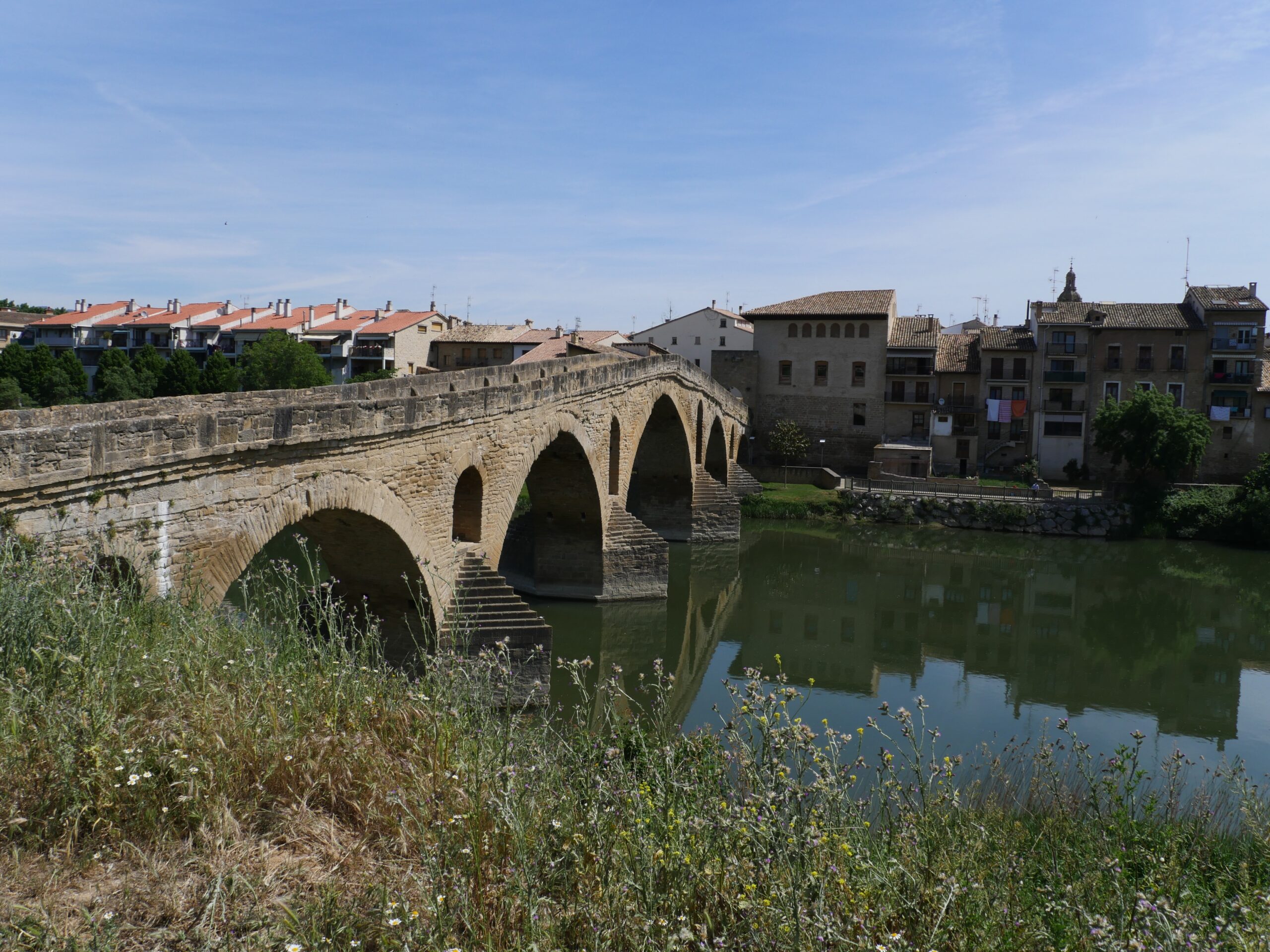 A famous, six-arched bridge allows hikers to cross the river in Puente La Reina, Spain.