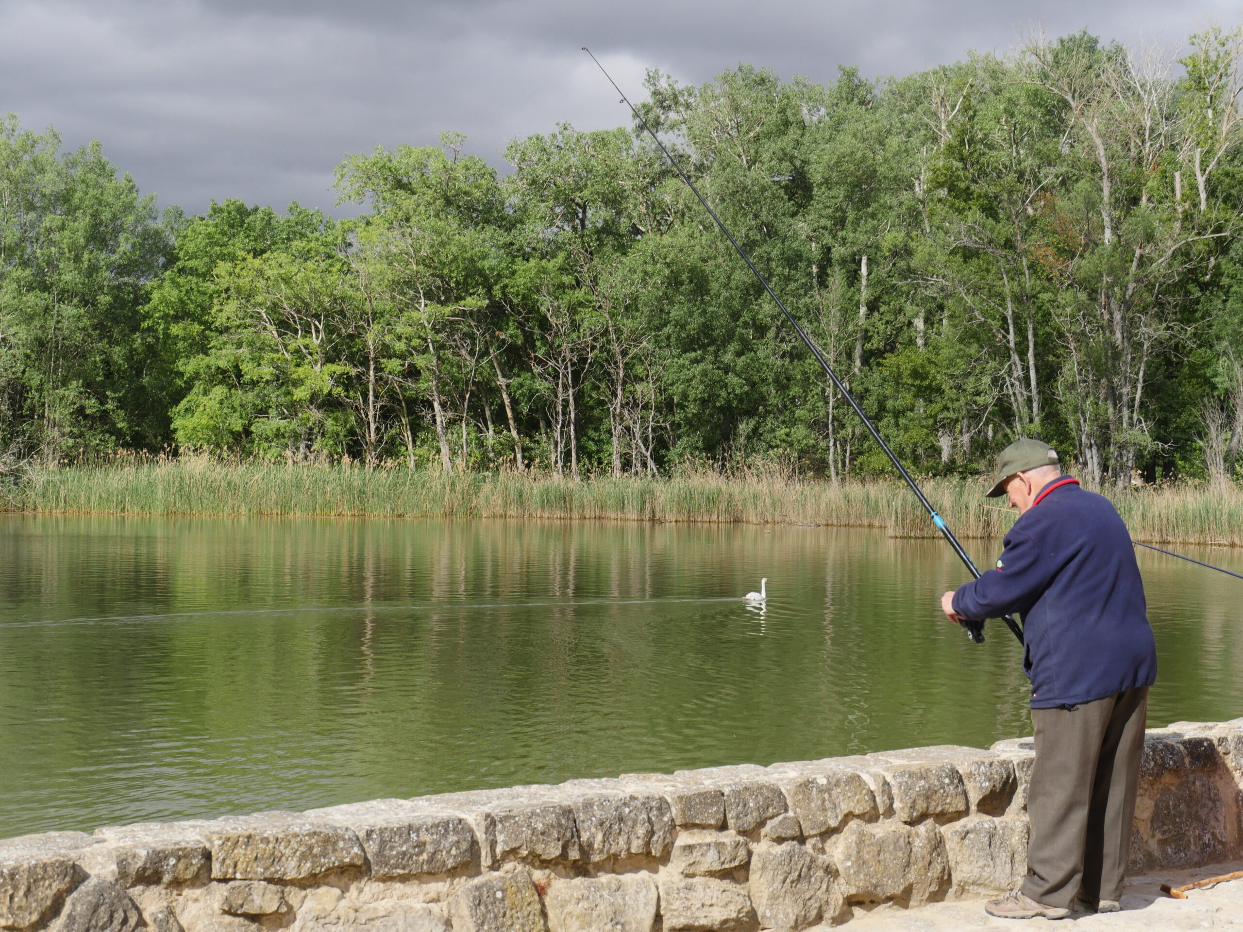 A man fishes in a lake near Logroño, Spain.
