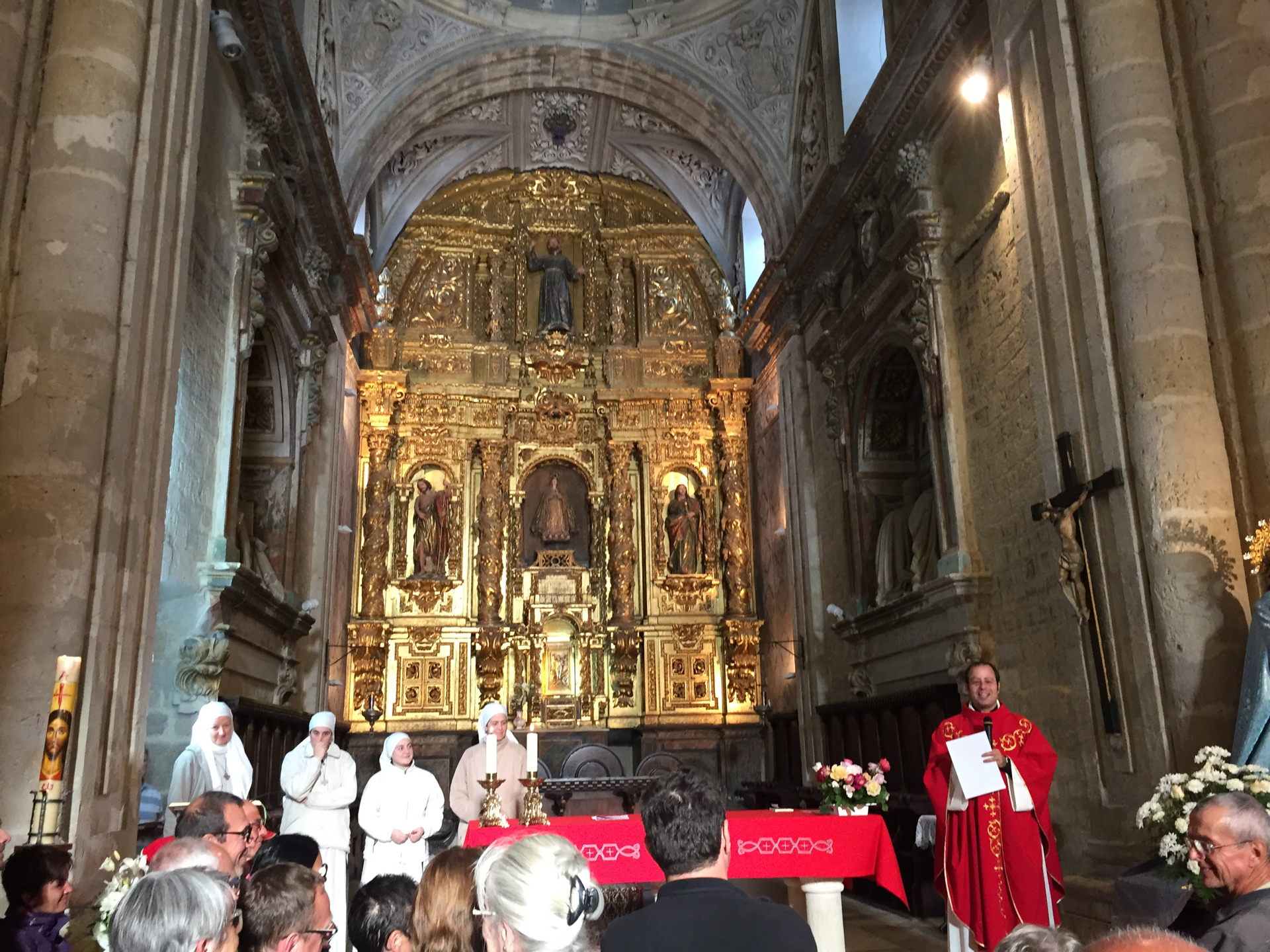 A priest performs a pilgrim blessing in the Church of Santa María in Carrión de los Condes, Spain.