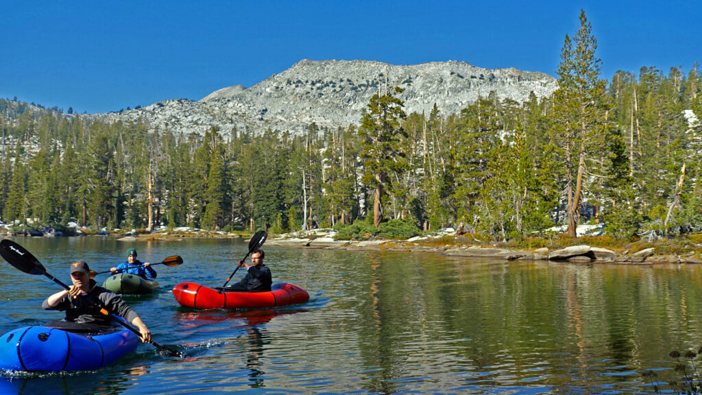 Rich, Hank, and Jake paddle packrafts around Rainbow Lake in Ansel Adams Wilderness.