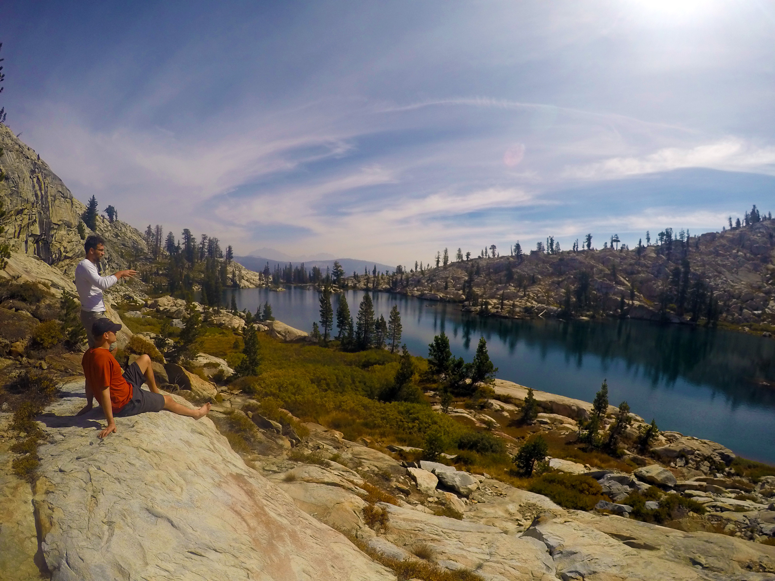 Hikers look out at Chittenden Lake in Ansel Adams Wilderness.