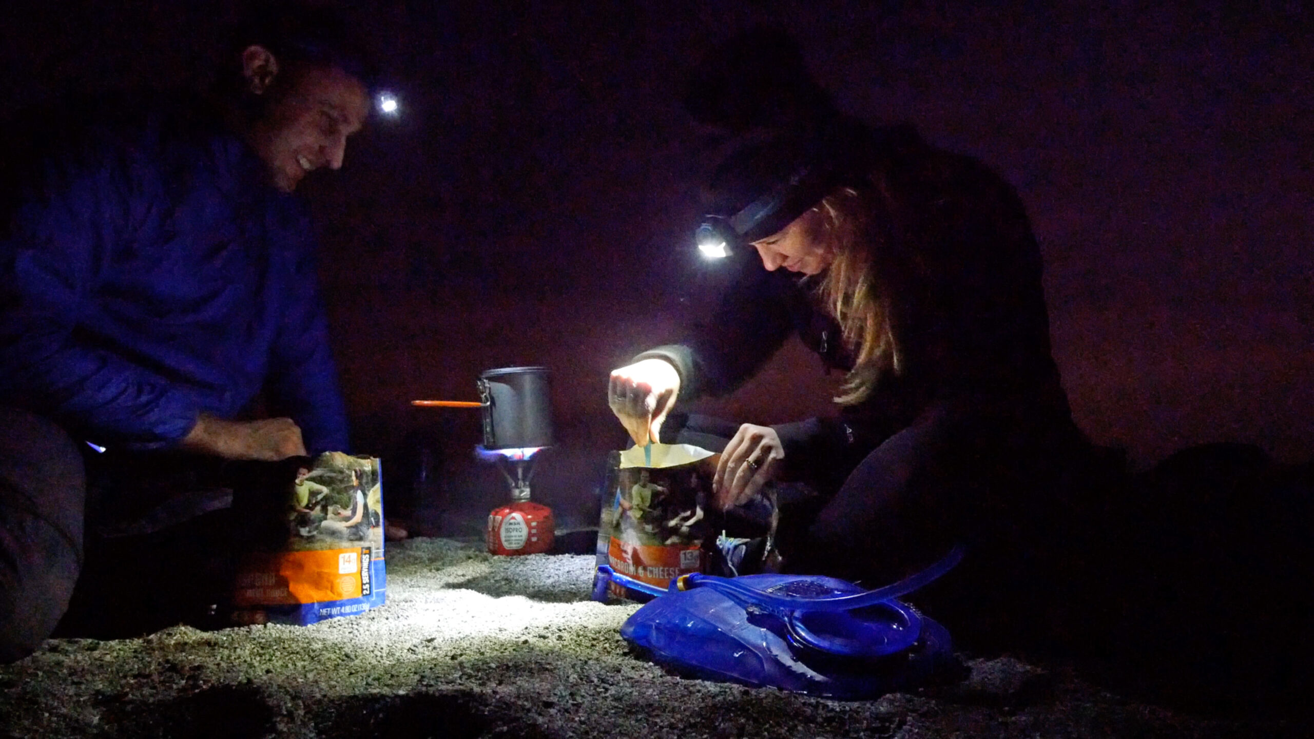 Hikers cook dinner at dusk above Starlight Beach at the end of the Trans-Catalina Trail on Catalina Island, California.