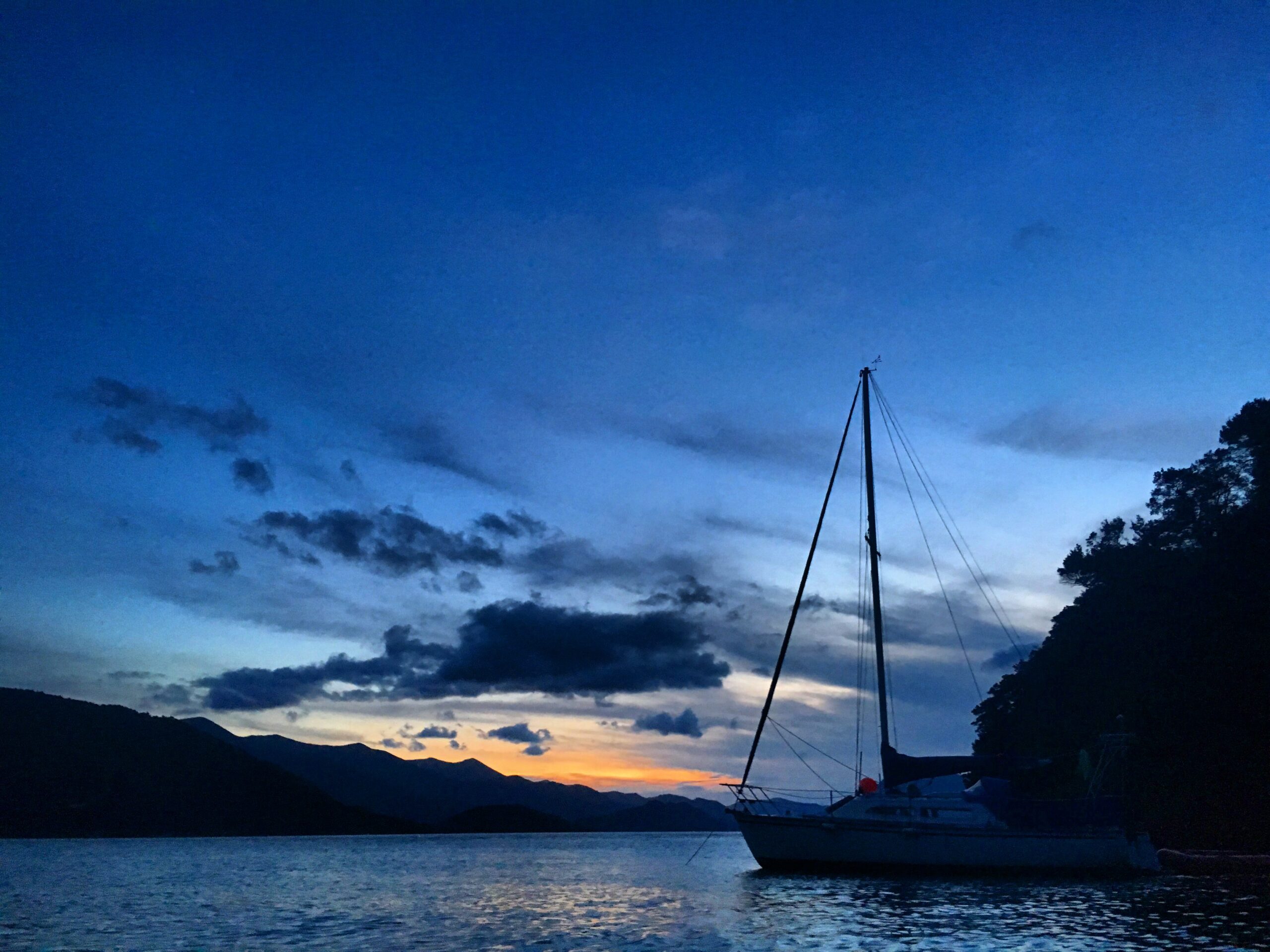 The sun sets over Kumutoto Bay in Queen Charlotte Sound, New Zealand.