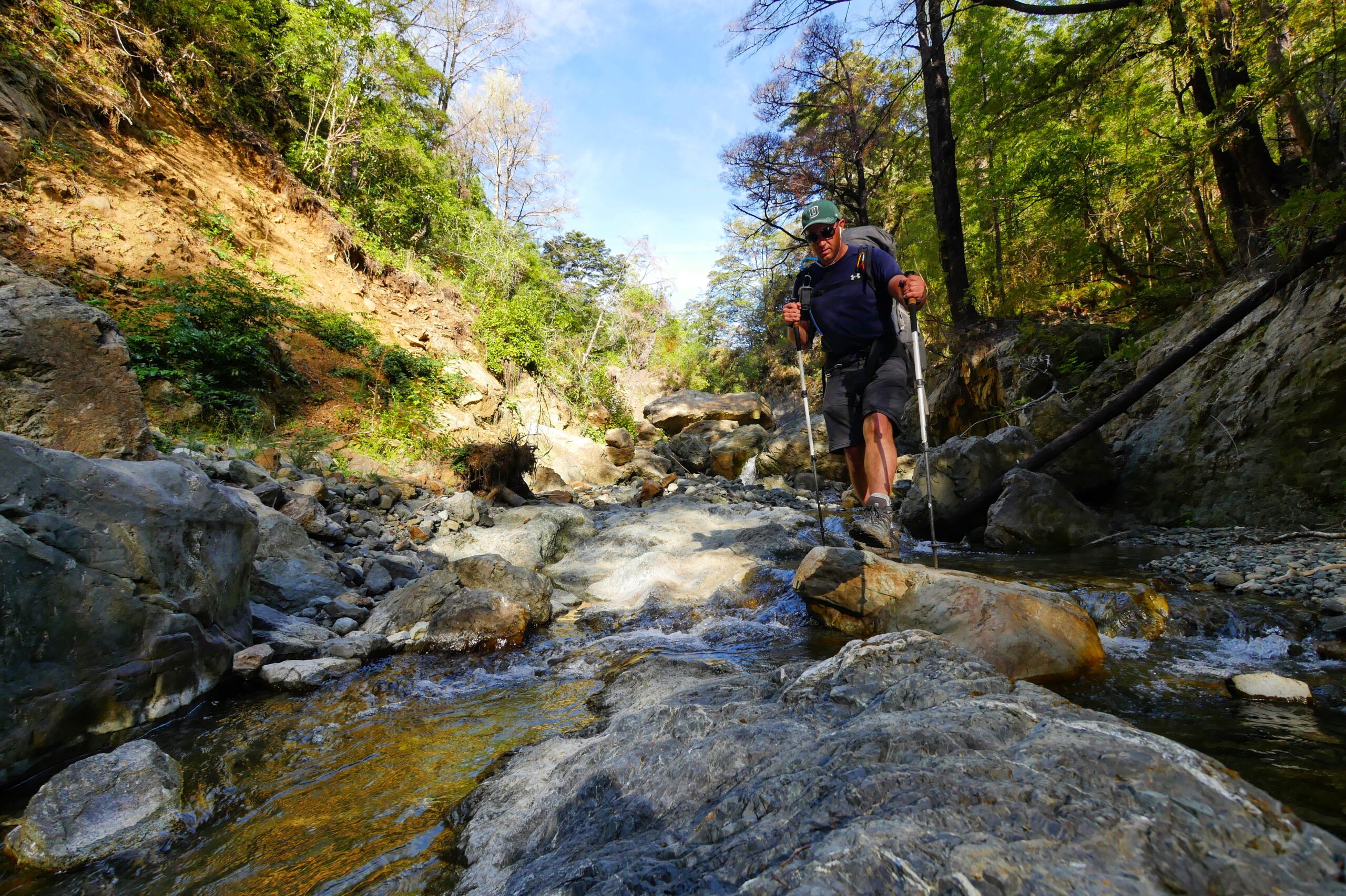 A hiker walks down the Pelorus River in New Zealand's Richmond Range.