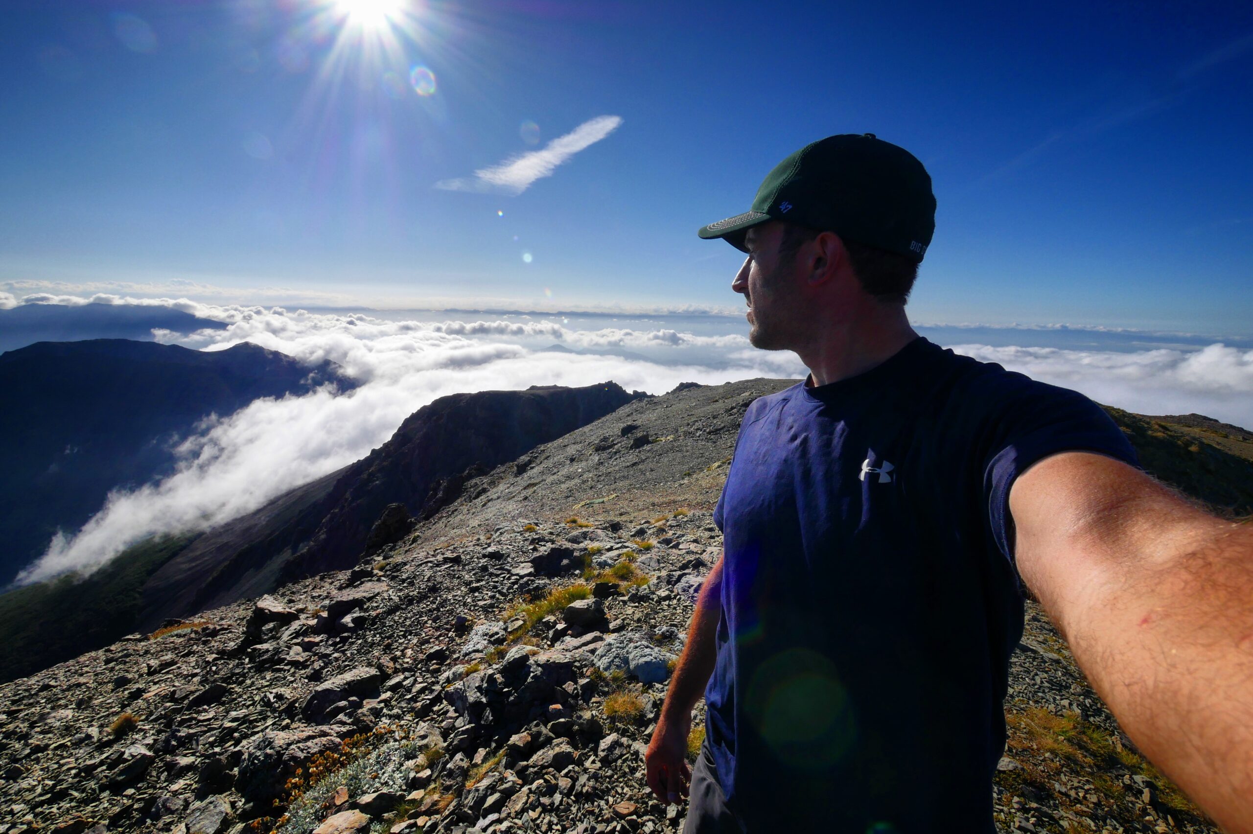 Hank admires the view above the clouds from the top of Mount Rintoul in New Zealand's Richmond Range.