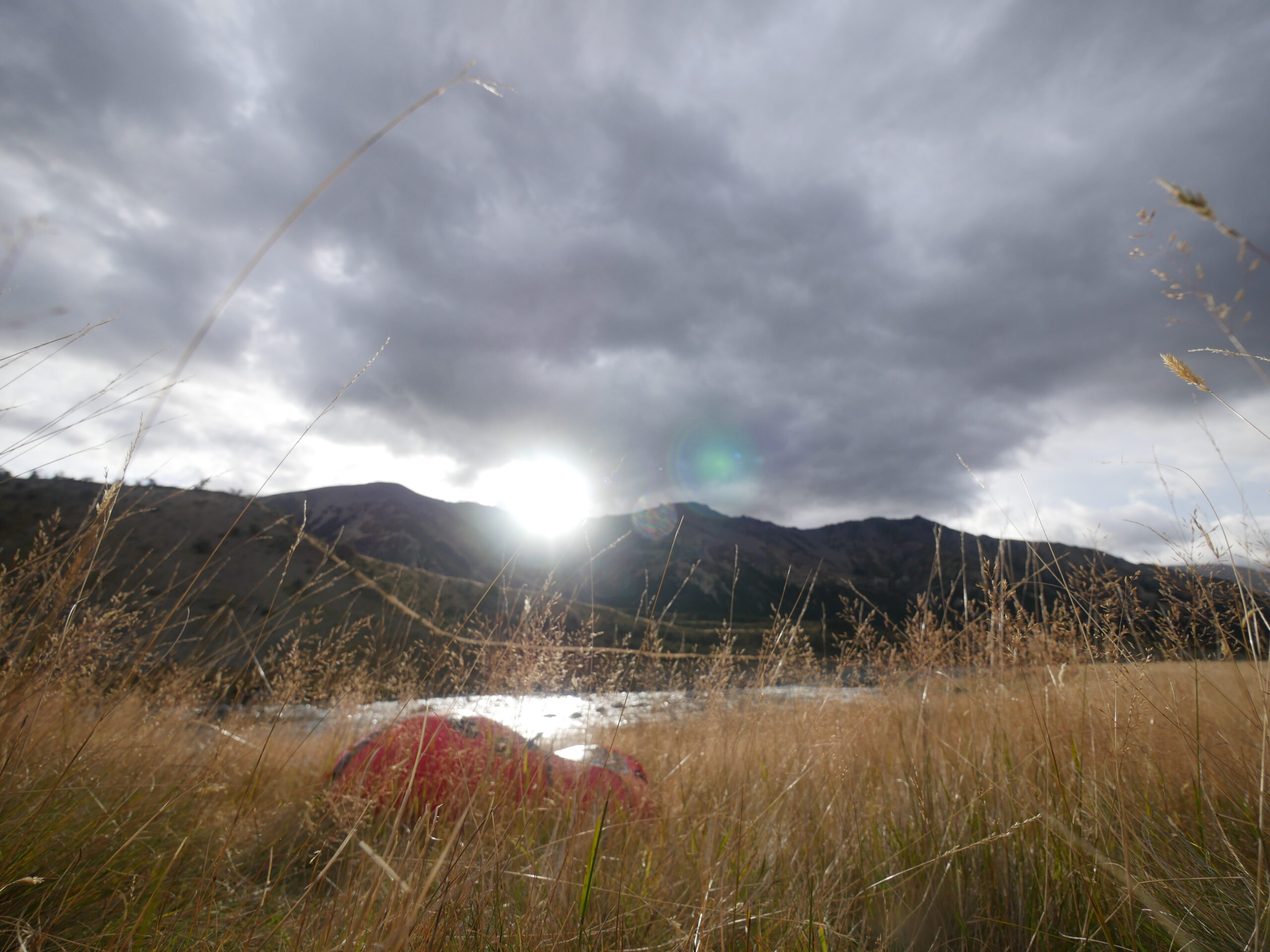 A packraft sits next to the Waiau River.