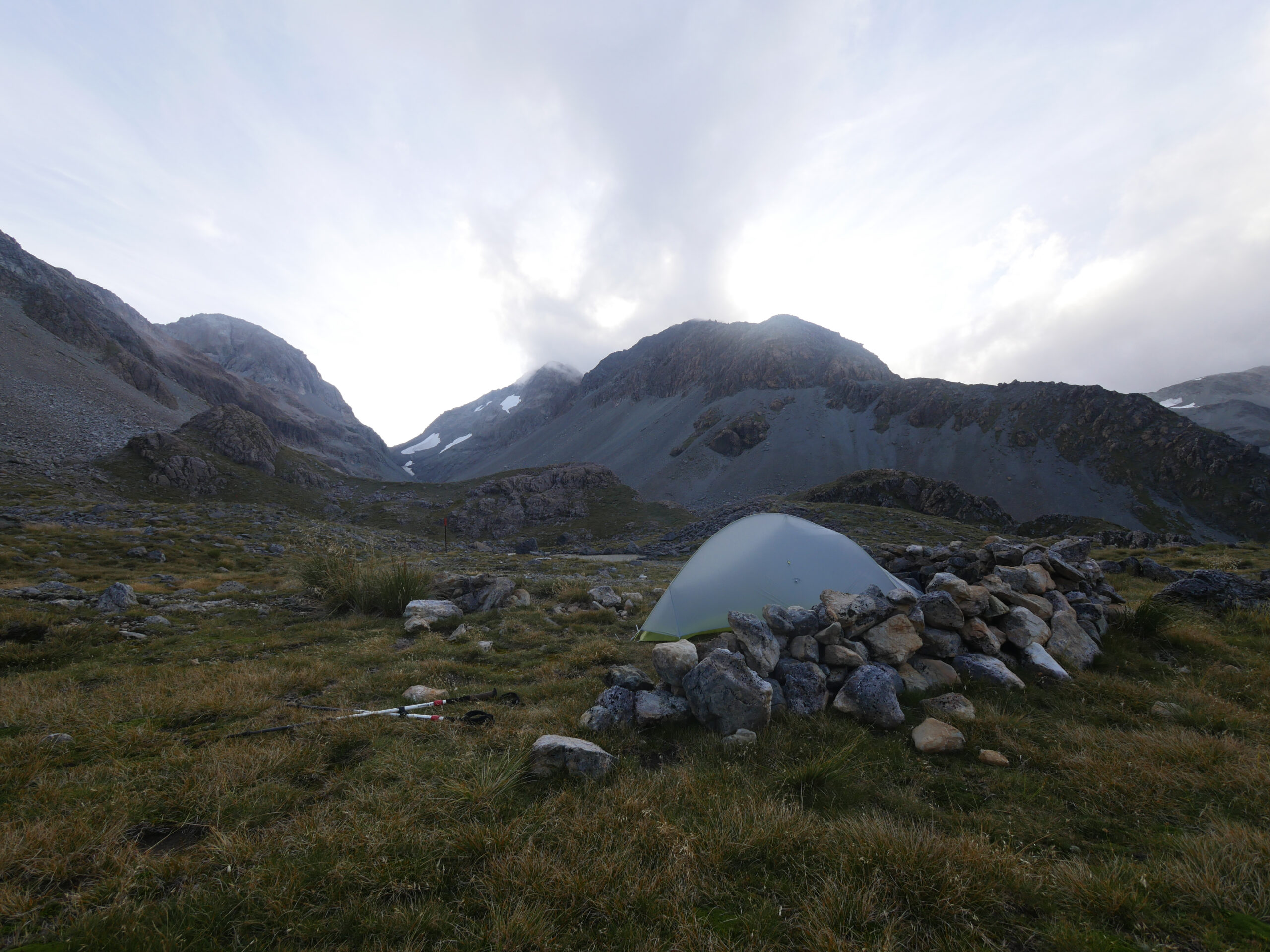 Camping behind a rock wall makes the high winds atop Harman Pass more tolerable.