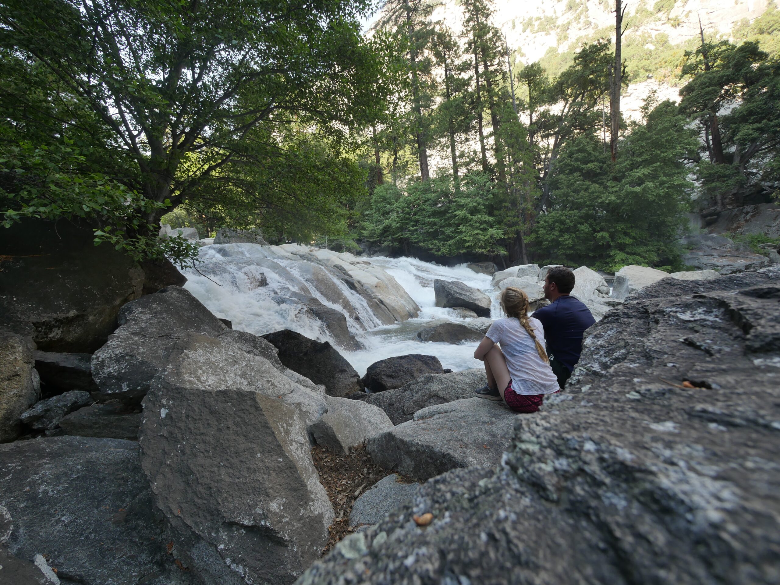 Hikers sit next to the Kings River in Kings Canyon National Park, California.