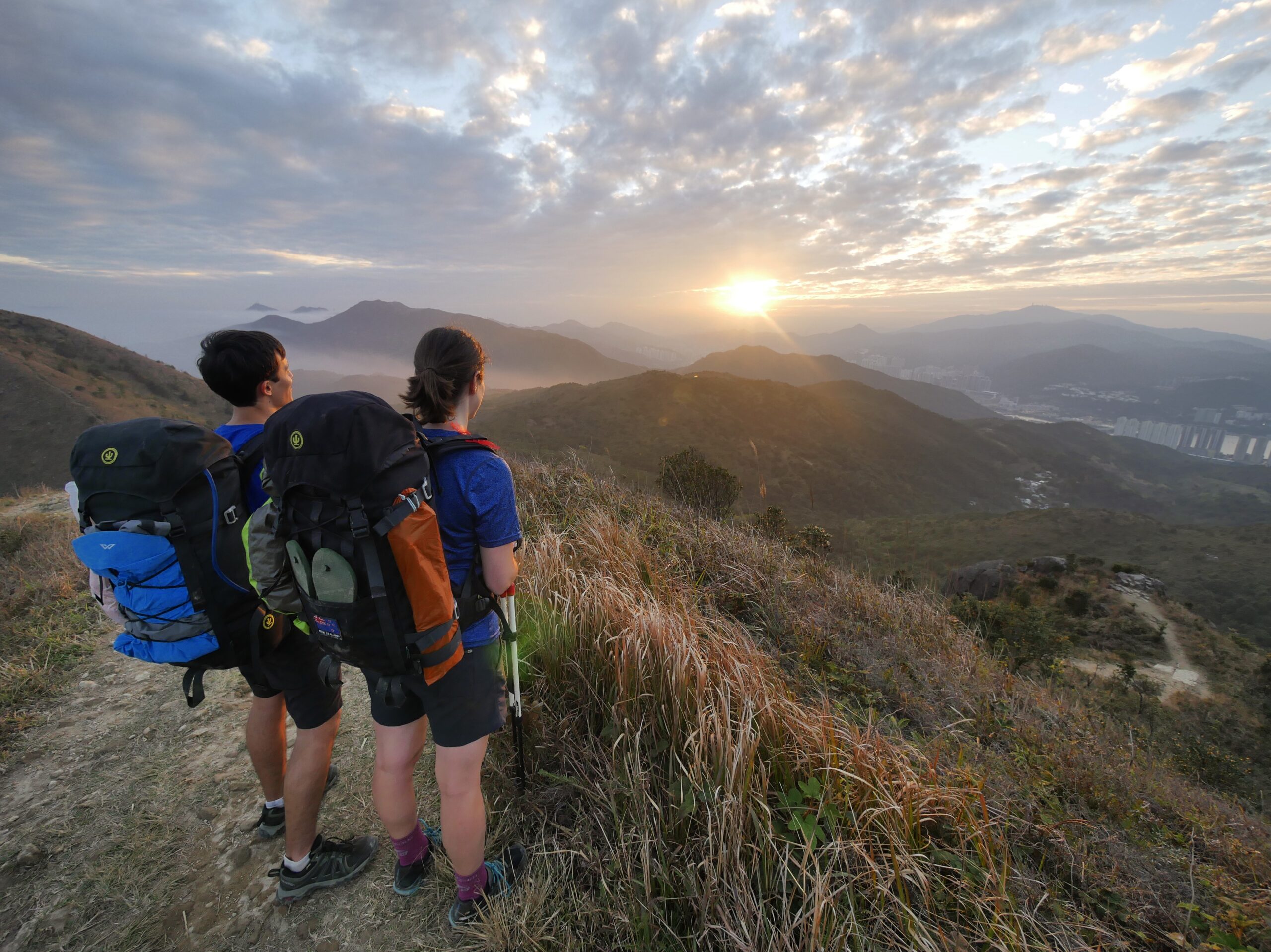 Hikers watch a sunset on the Maclehose Trail