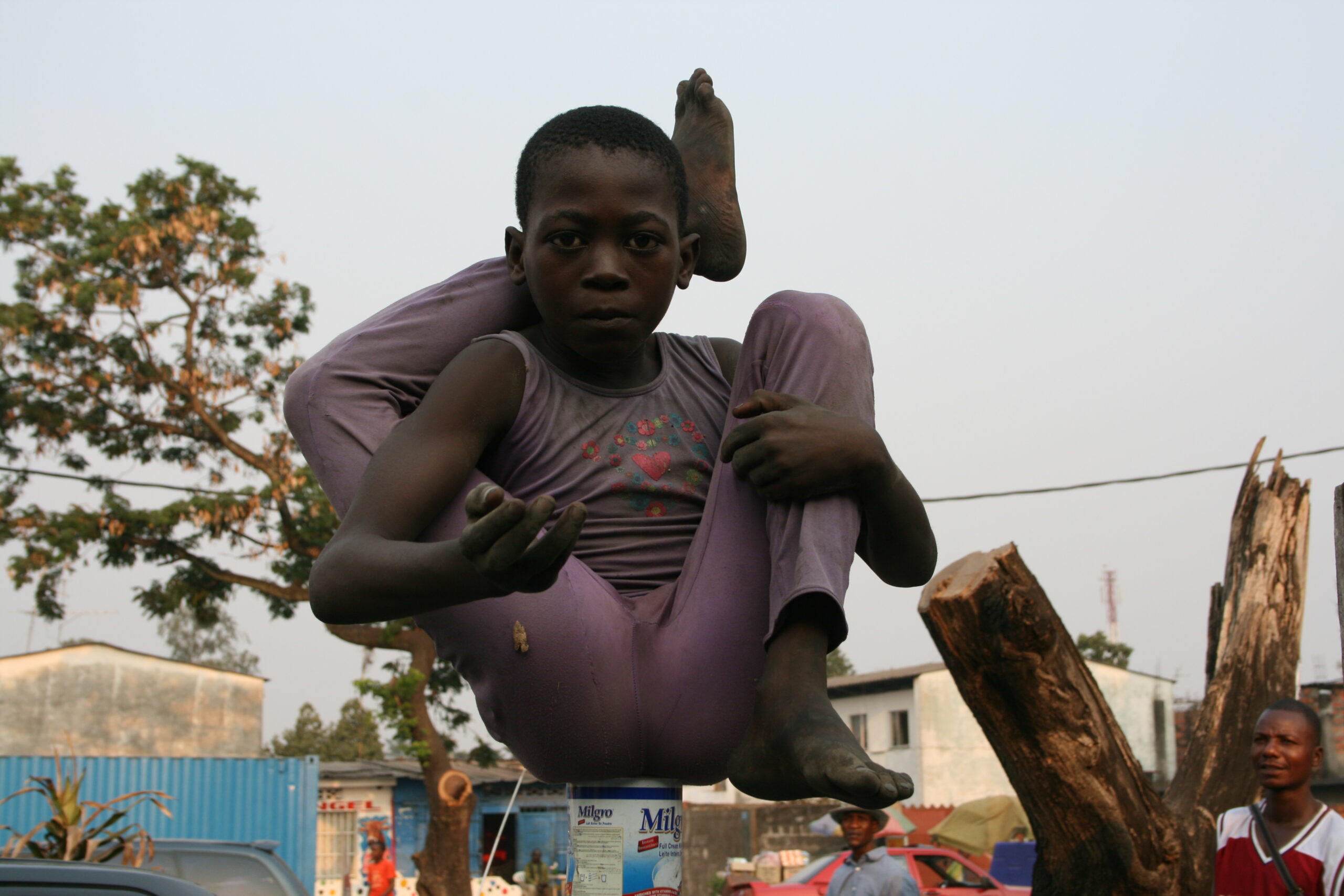 Child performing circus act asking for money