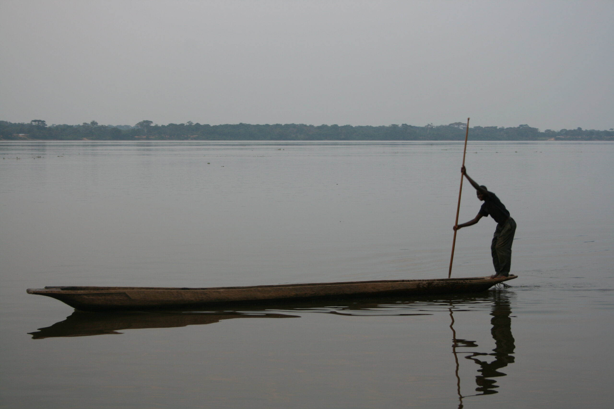 Man paddling pirogue near Yanonge