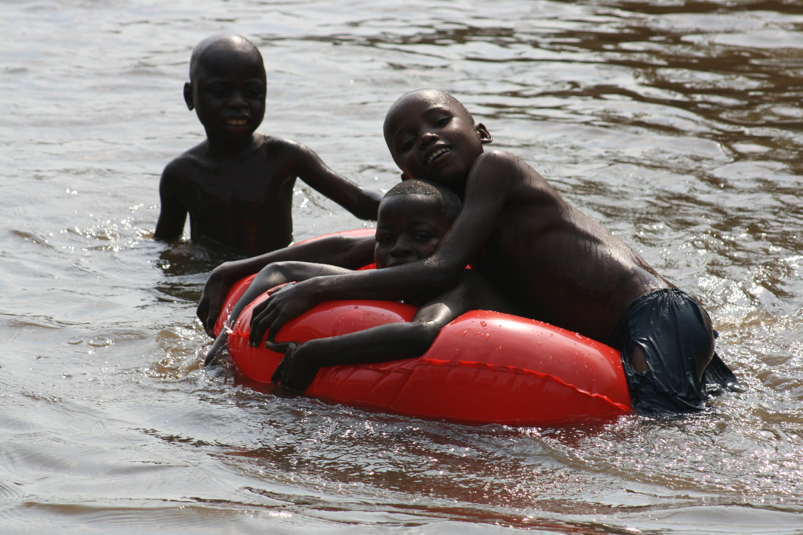 Kids playing in tube in water in Yangambi