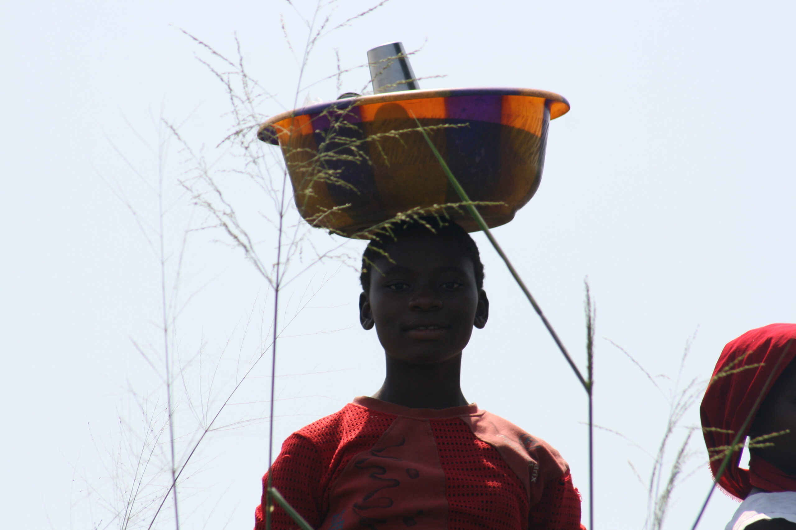 Child with bucket on head in Bumba