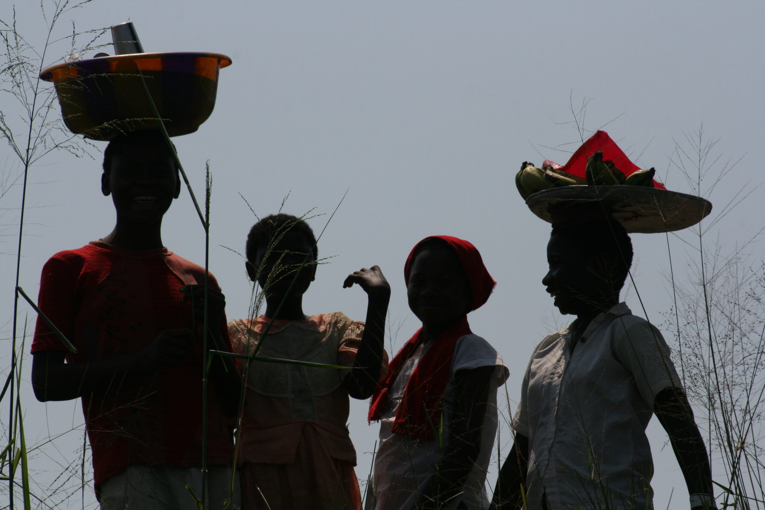 Bumba villagers with buckets on head