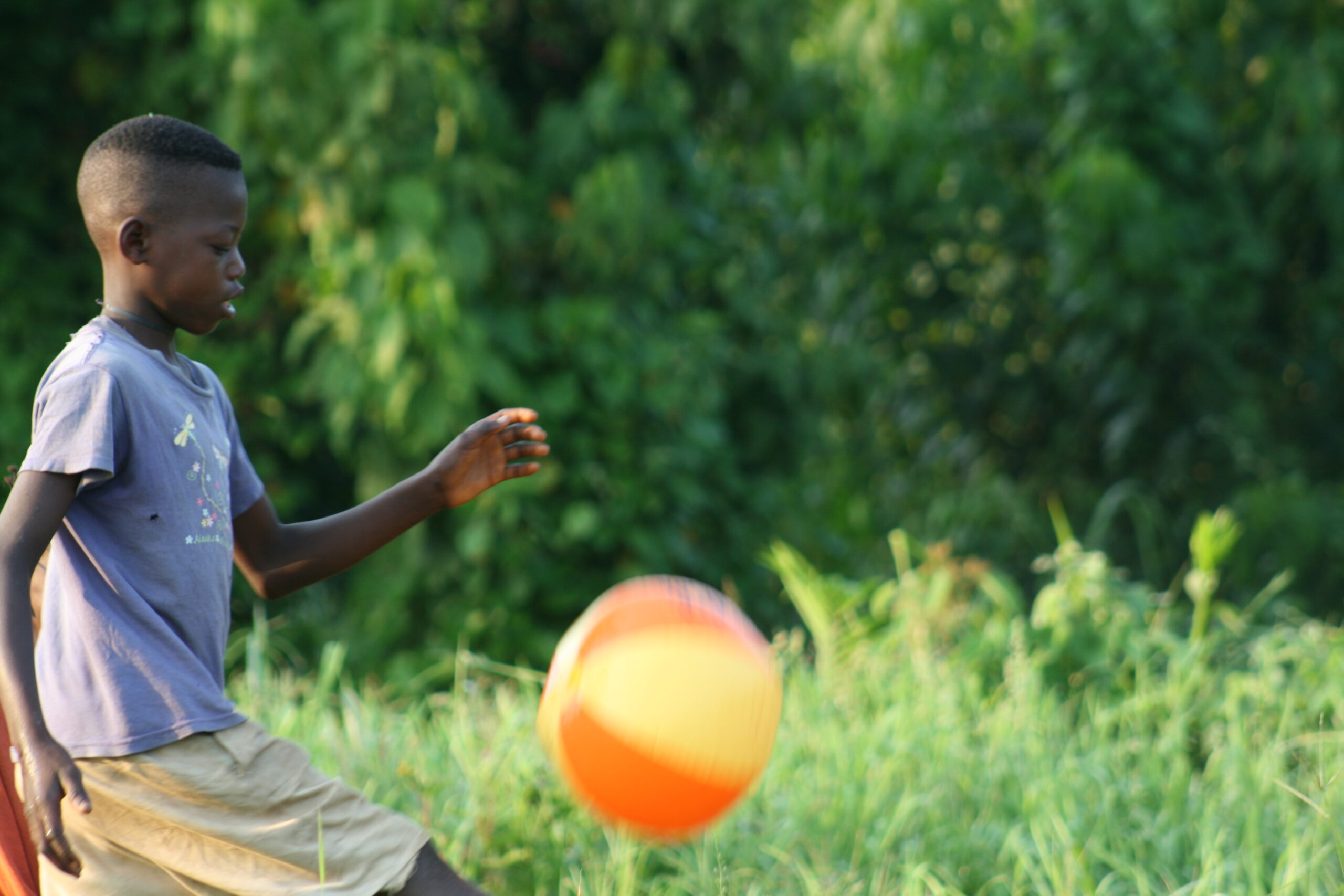 Child playing with ball in Malonbolombo village