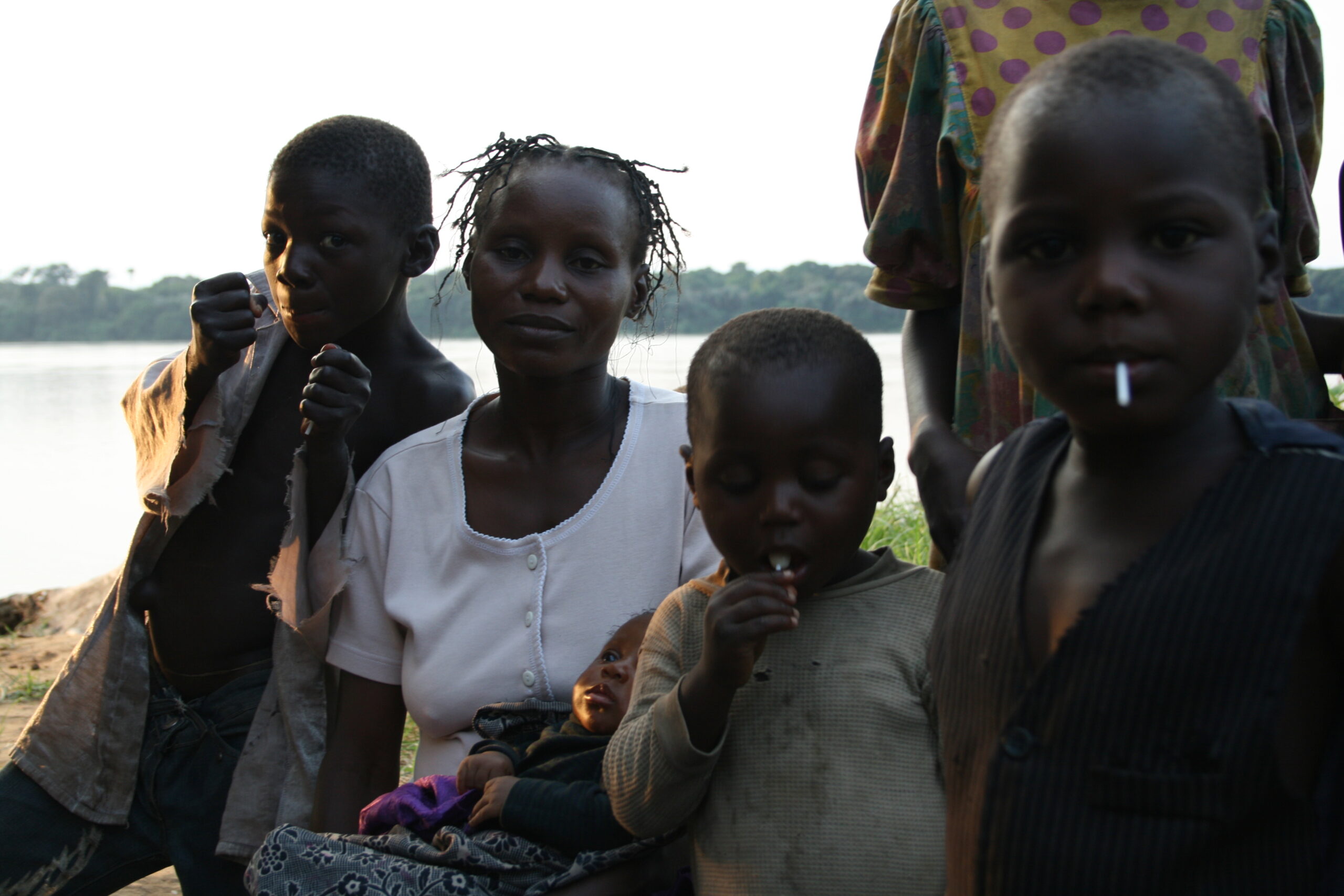 Children with lollipops, mother in Esabe village