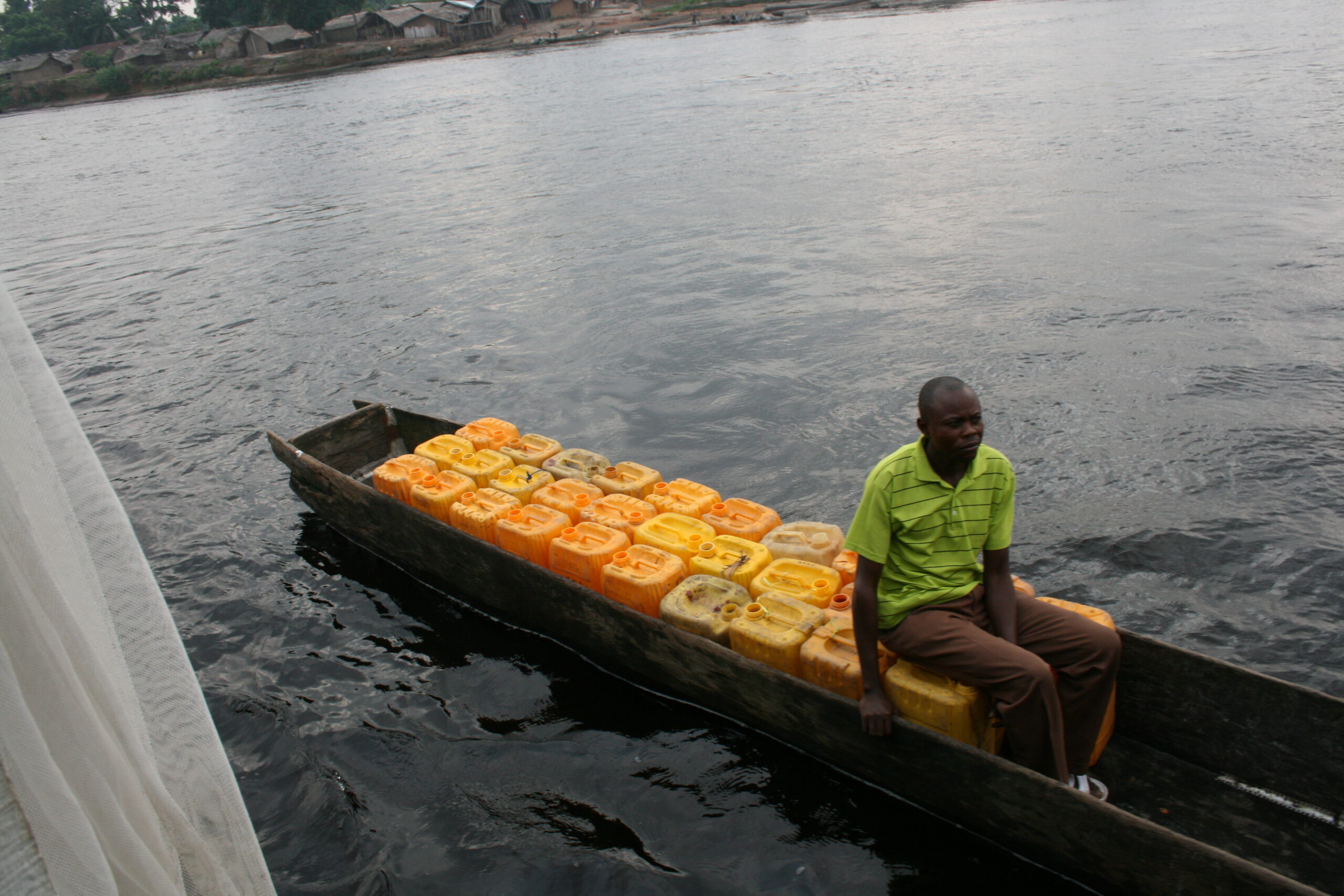 Man with gas containers in pirogue
