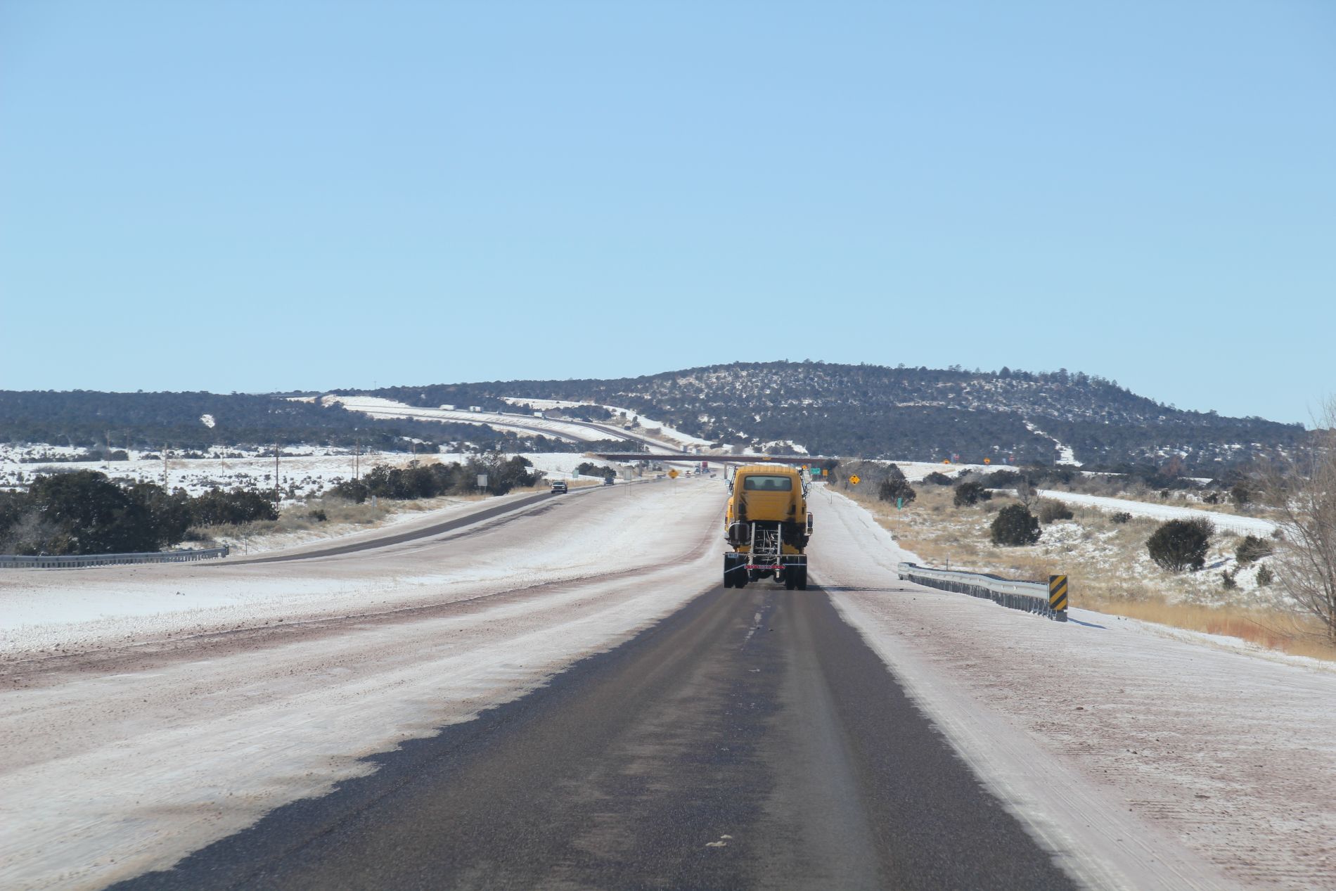 Snow plow on snowy road near Santa Rosa, New Mexico