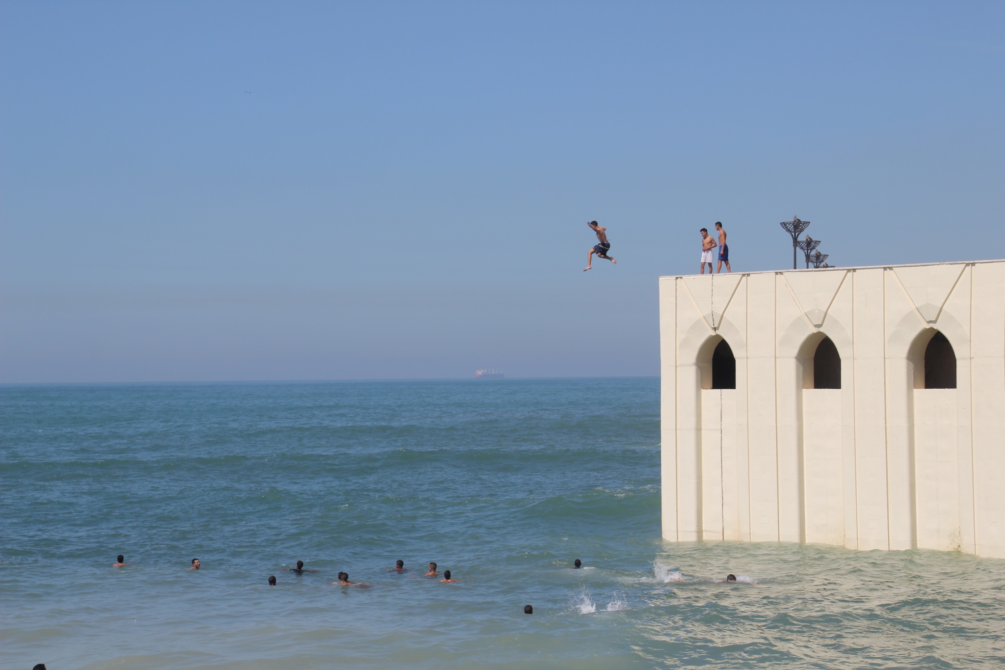 Kids jumping into water near King Hassan II Mosque