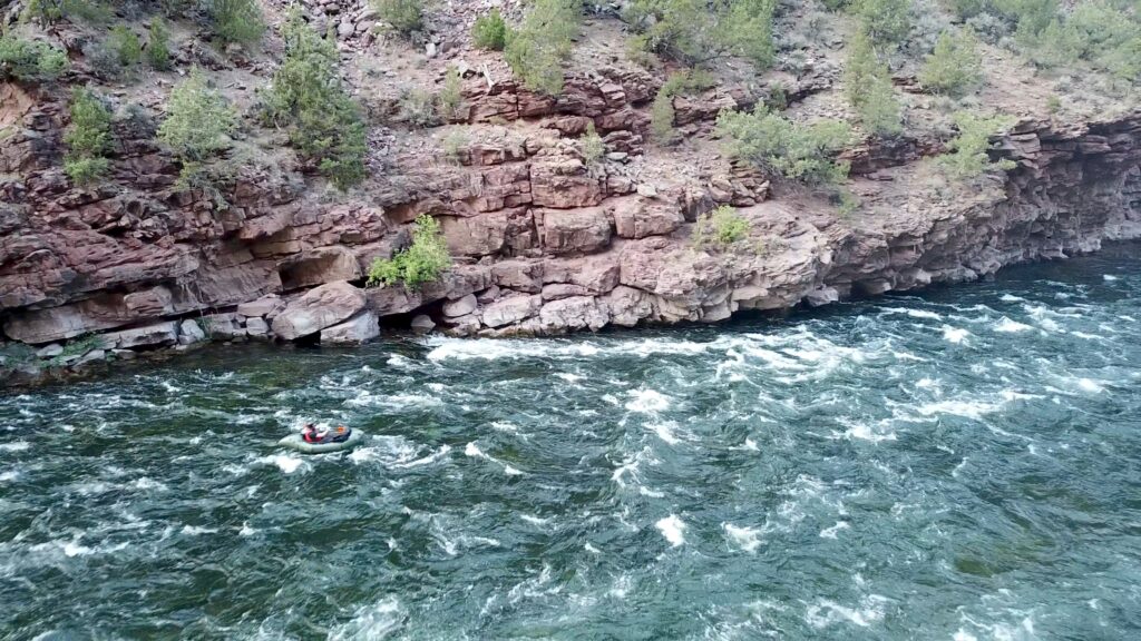 A packrafter runs Mother-In-Law Rapid in Flaming Gorge